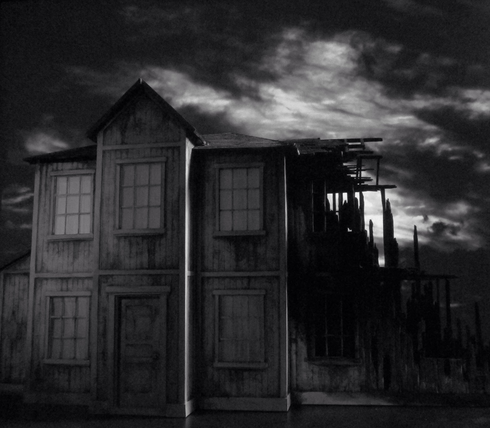 Photo of miniature constructed from balsa wood with rear projection of clouds.