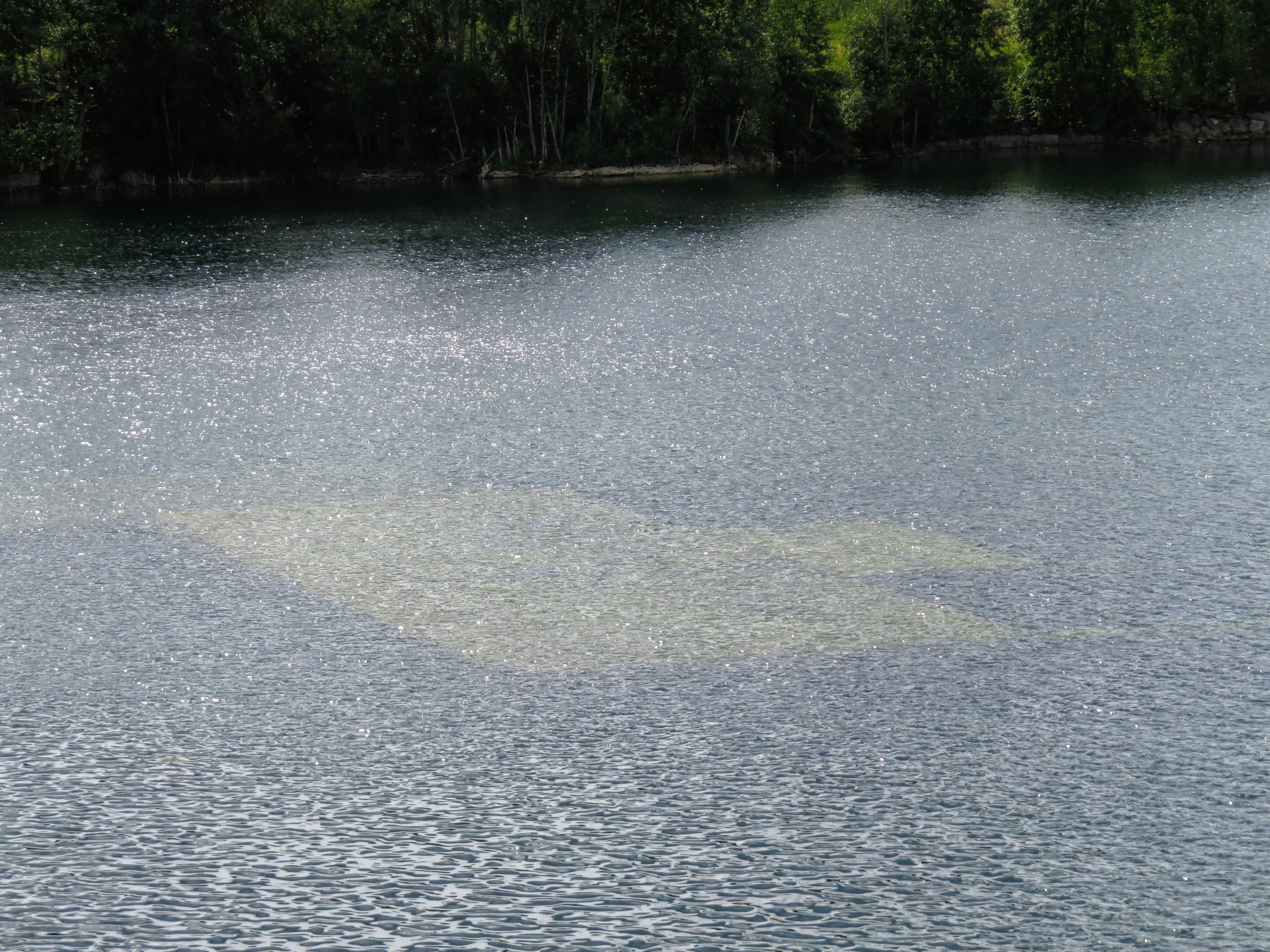 The former prison, entirely submerged below the surface of the flooded quarry.