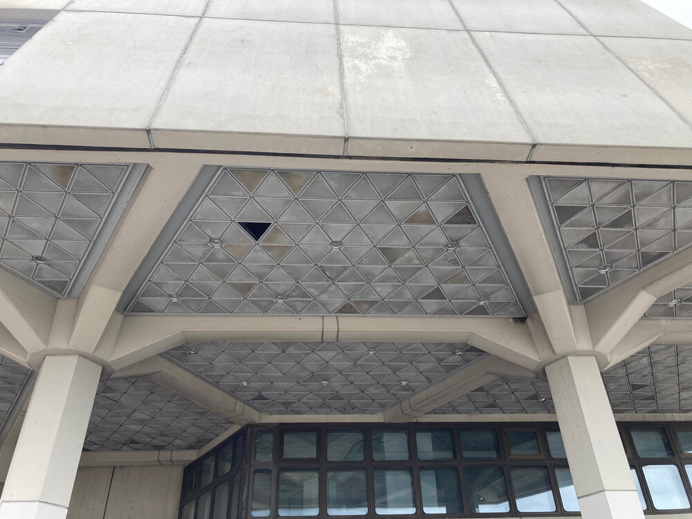 A missing piece of the tessellated triangular roof outside the main terminal now offers a prime spot for pigeons to nest.