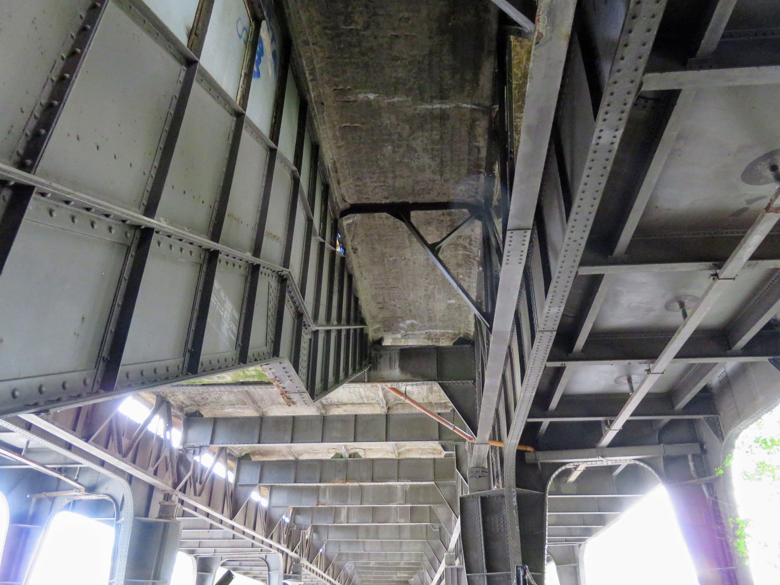 The riveted ironwork of the tracks and stairway under the platform of the former Bahnhof Wernerwerk.