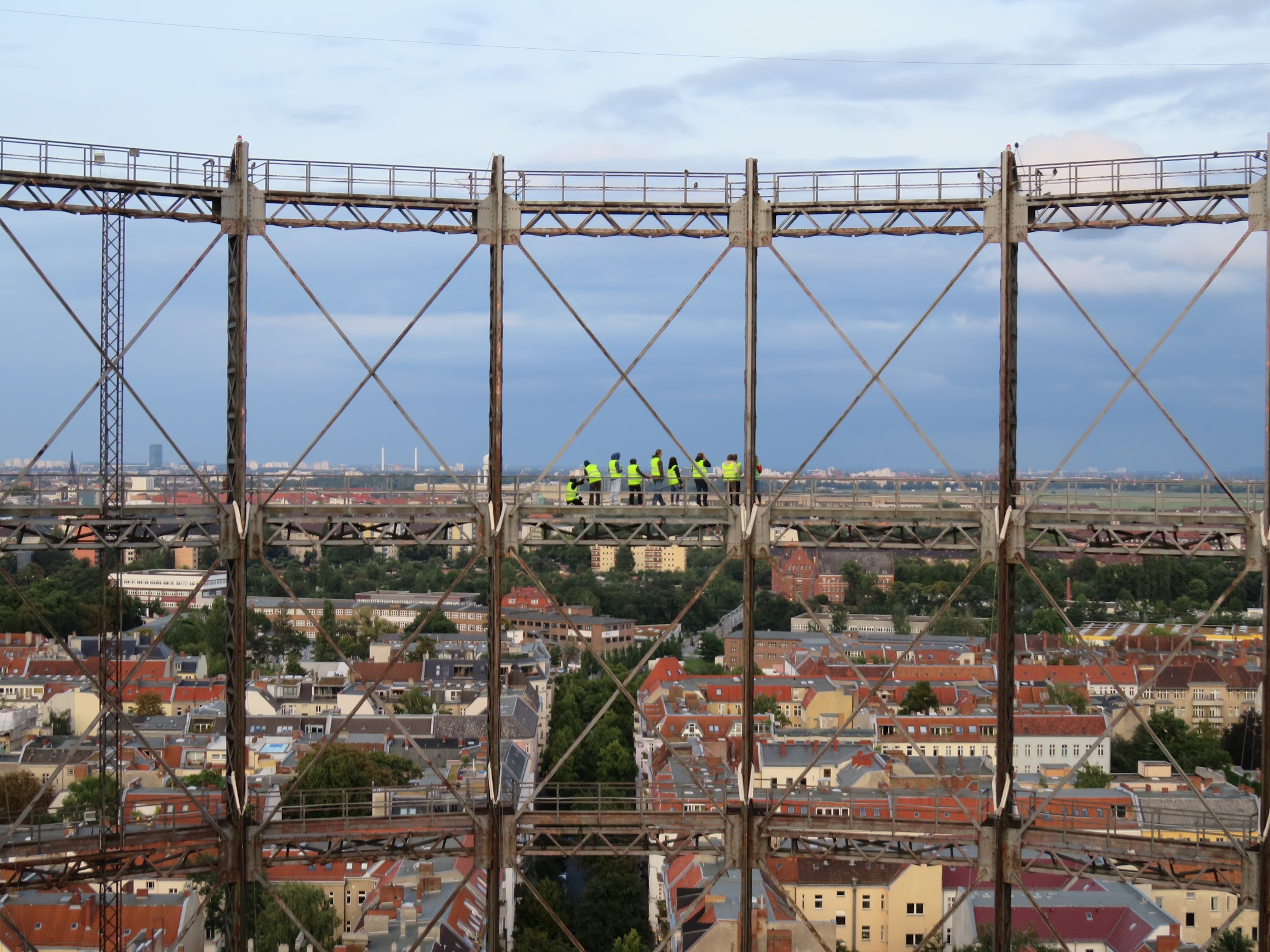 The view across the center of the structure, with a group of yellow-vested visitors for scale.