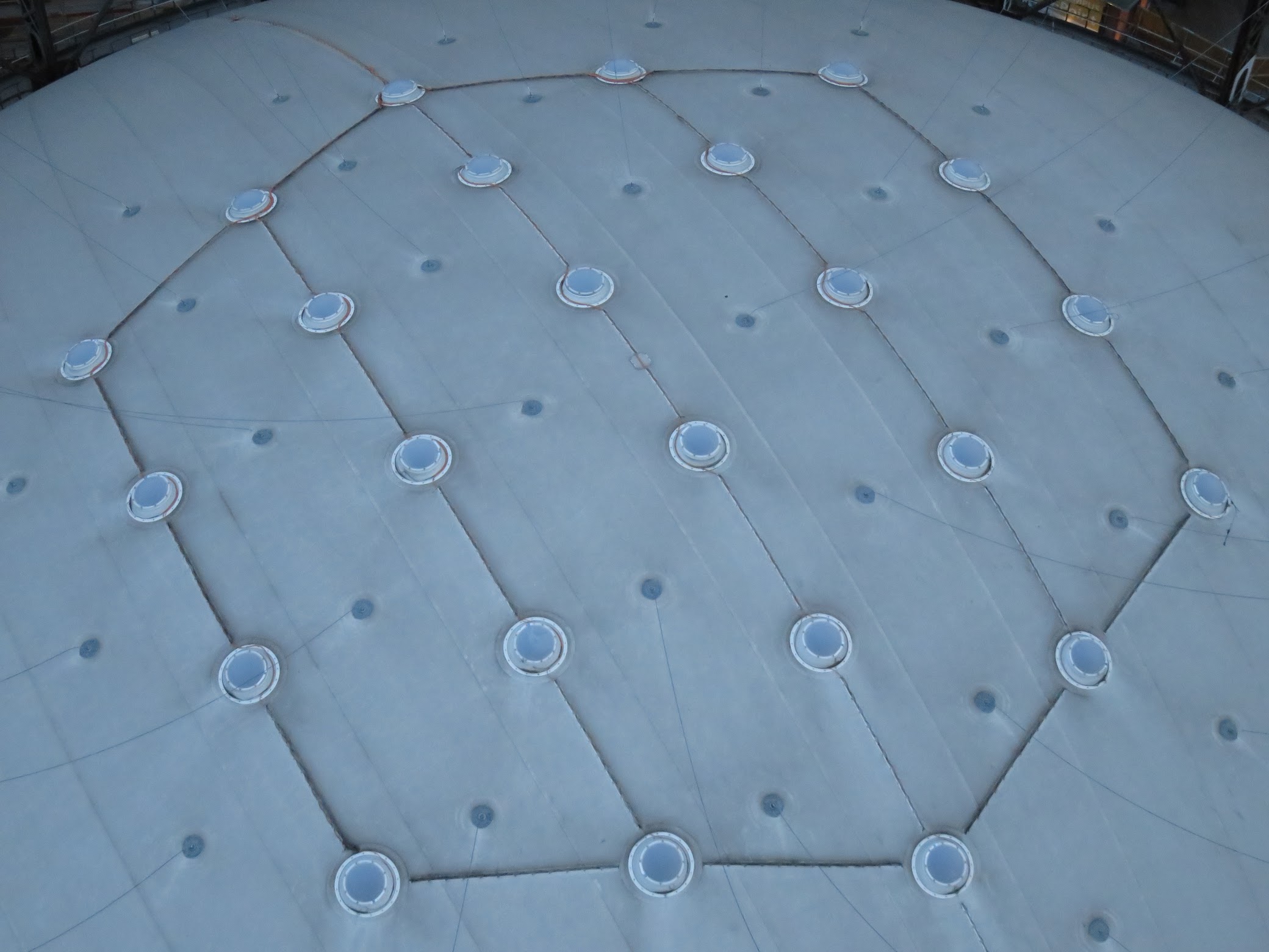 The roof of the modern hall at the foot of the structure.
